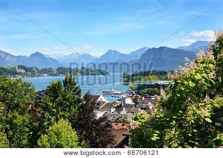 LUCERN, SWITZERLAND - JULY 3, 2014: Overview of Lucern City, the lake and Alps. From the Musegg Wall you get a stunning view of the city and lake, art museum and the alps in the distance.