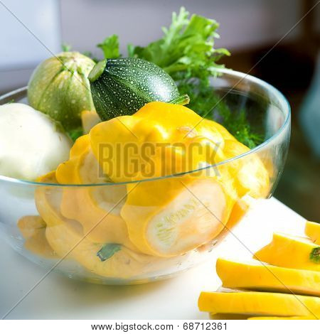 fresh zucchini and squash in a glass bowl