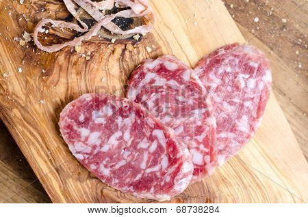 Sliced Salami On A Wood Board