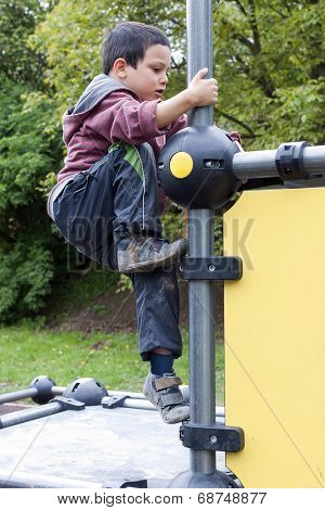 Child Climbing At Playground