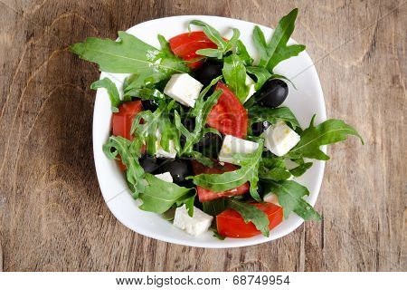 Greek Salad In White Salad Bowl On The Table