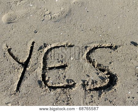 Written Yes Engraved On The Sand Of The Sea Beach
