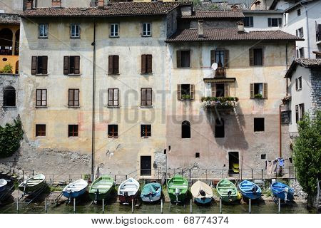GANDRIA, SWITZERLAND - JULY 5, 2014: Boats on the shore at Gandria on Lake Lugano. Private boats lined up on the shore at the foot of a building on Switzerland's Lake Lugano.