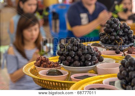 Nakornpathom, Thailand - Jul 5, 2014 : Grapes And Many Black Thing To Give To 