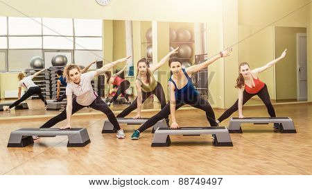 Group Of Women Making Step Aerobics