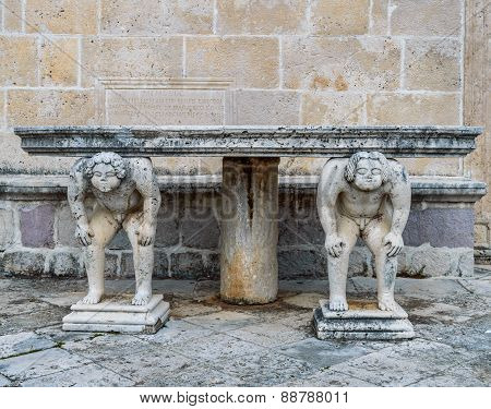 Stone table which stands on two carved titans, Perast