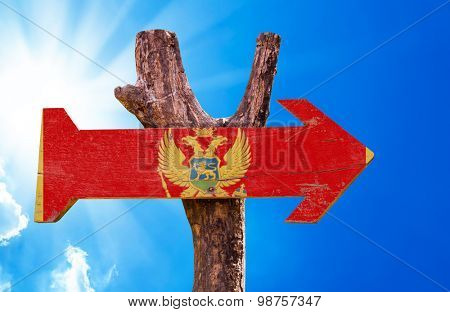 Montenegro Flag wooden sign with sky background