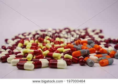 Colorful of antibiotic capsule medicine pills on white background