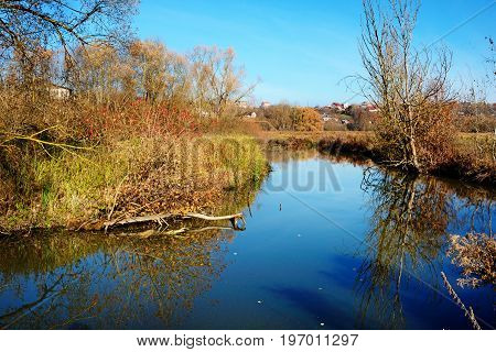 A View Of The Blue Water Flow And Vegetation In The Countryside.