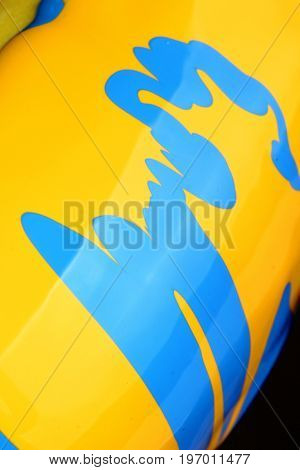 Pouring blue paint over yellow background, macro closeup.Texture.Abstract