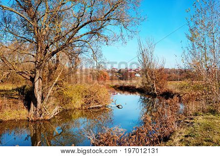 A View Of The Blue Water Flow And Vegetation In The Countryside.