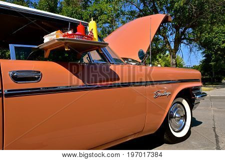WEST FARGO, NORTH DAKOTA, July 20, 2017:  The West Fargo Cruise night occurs each 3rd Thursday night in the summer months and features classic cars such as this side profile of a  Chyrsler Saratoga at a drive-in.