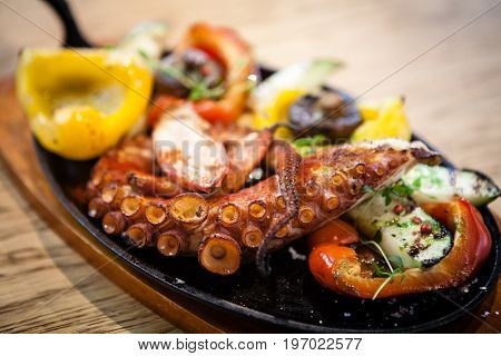 Pulpo cocido. Boiled octopus, shallots and grilled vegetables