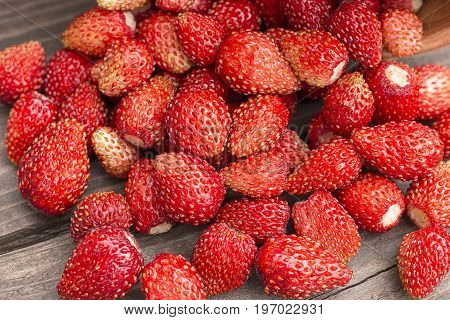 Ripe fresh strawberries on rustic wooden background. Top view.