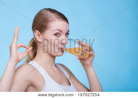 Woman Drinking Orange Flavored Drink Or Juice
