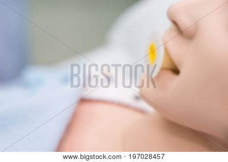 Blurry Background of Dummy patient on Oropharyngeal Airway to open her airway.