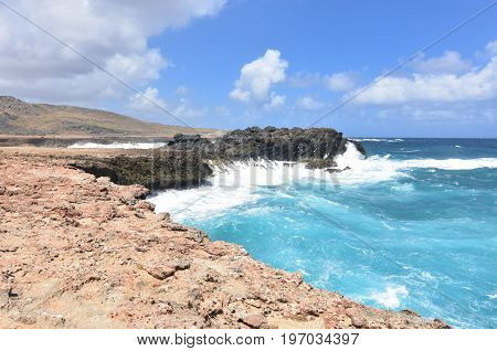 Splashing ocean waves crashing on to the shore of Aruba's eastern coast.