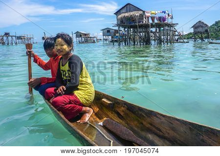 Semporna,Sabah,Malaysia-Apr 23,2017:Sea Gypsy kids on unique handmade boats with clear water on at Bodgaya island,Semporna,Sabah,Malaysia.