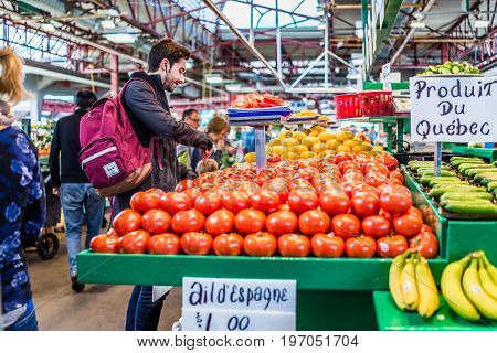 Montreal, Canada - May 27, 2017: Man Buying Produce By Tomato Stand With Sample Slices At Jean-talon