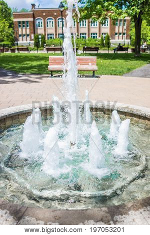 Montreal, Canada - May 27, 2017: Green Fountain With Running Water And Bench In Sir Wilfred Laurier