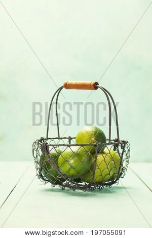 Mojito cocktail ingredients (fresh mint, lime, ice) on rustick background