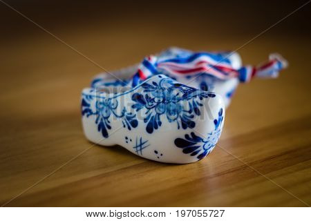 BERLIN - JUNE 03 2015: Traditional souvenirs from Holland. Ceramic shoes (Klompen). Focus on the foreground. Shallow DOF.