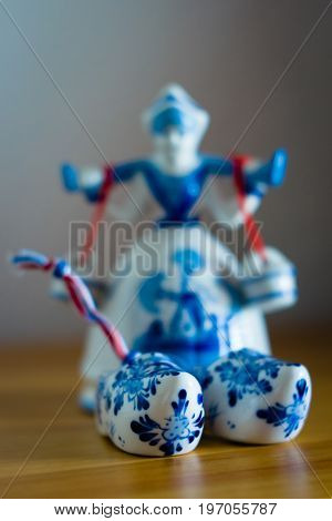 BERLIN - JUNE 03 2015: Traditional souvenirs from Holland. Ceramic shoes (Klompen). Focus on the foreground. Shallow DOF.