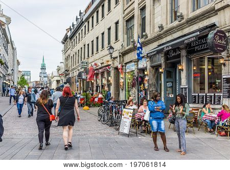 Montreal, Canada - May 27, 2017: Old Town Area With People Walking Up Street In Evening Outside Rest