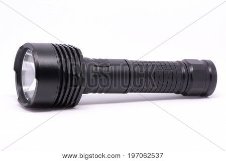 Isolated black metal flashlight on white background