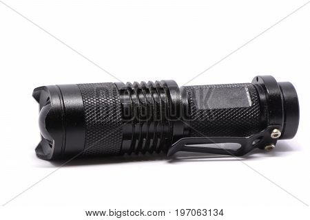 Isolated black metal flashlight on white background