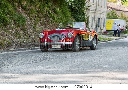 GOLA DEL FURLO, ITALY - MAY 19: AUSTIN HEALEY 100/4 1956 on an old racing car in rally Mille Miglia 2017 the famous italian historical race (1927-1957) on May 19 2017