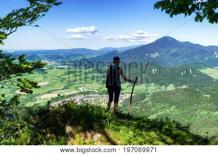 Hiking woman watching from top of the hill Hrdos (Ostre) and watching on beautiful summer landscape