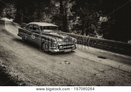 GOLA DEL FURLO, ITALY - MAY 19: OLDSMOBILE 88 1953 on an old racing car in rally Mille Miglia 2017 the famous italian historical race (1927-1957) on May 19 2017