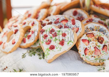 Homemade gingerbread in sugar glaze with dried fungi of different shapes