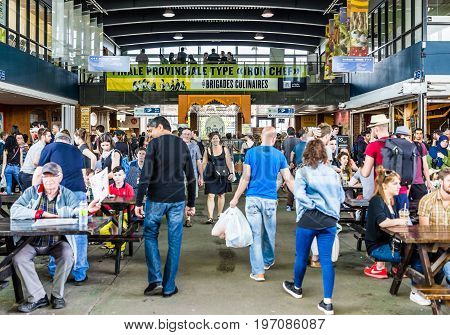 Montreal, Canada - May 28, 2017: Jean Talon Market Sign And Entrance With People Inside Building Eat