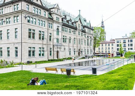 Quebec City, Canada - May 29, 2017: Couple Relaxing In Park In Old Town By Hotel De Ville City Hall