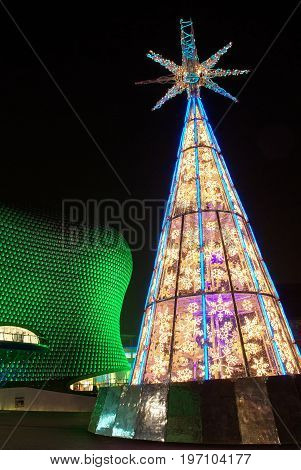Christmas tree and illuminated Bullring Shopping centre in Birmingam at night