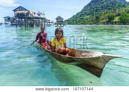 Semporna,Sabah,Malaysia-Apr 23,2017:Sea Gypsy kids on unique handmade boats surrounded by beautiful clear water of the Bodgaya island,Semporna,Sabah,Malaysia.