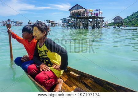 Semporna,Sabah,Malaysia-Apr 23,2017:Sea Gypsy kids on unique handmade boats surrounded by beautiful clear water of the Bodgaya island,Semporna,Sabah,Malaysia.