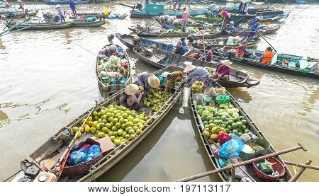 Can Tho, Vietnam - January 22, 2017: View above farmers purchase crowded in floating market with dozens boats along river trade agricultural products serves traditional New Year in Can Tho, Vietnam