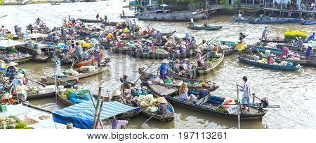 Can Tho, Vietnam - January 22, 2017: Farmers purchase crowded in floating market morning with dozens boats along river trade agricultural products serves traditional New Year in Can Tho, Vietnam