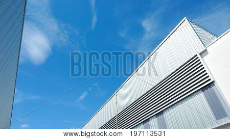 Factory warehouse and industrial concept - Wall and roof of Factory or warehouse building in industrial estate with blue sky and copyspace