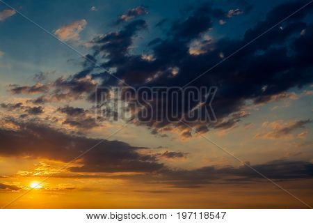 Dramatic sunset sunrise sky with dark blue clouds