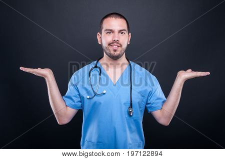 Doctor Wearing Scrubs With Stethoscope Holding Copypsace Both Hands