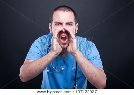 Doctor Wearing Scrubs With Stethoscope Screaming Out Loud