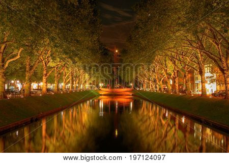 the konigsallee in dusseldorf is illuminated at night