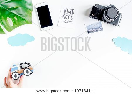 planing trip with child with mobile and camera on white background top view space for text