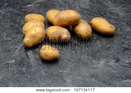 Potatoes on black background close up photo