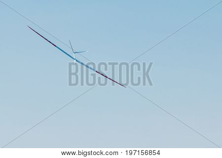 RC remotely controlled soaring plane model sailplane on blue sky in brisk wind