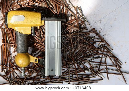 Air Nailer with rusty nail.Equipment for construction and industry.